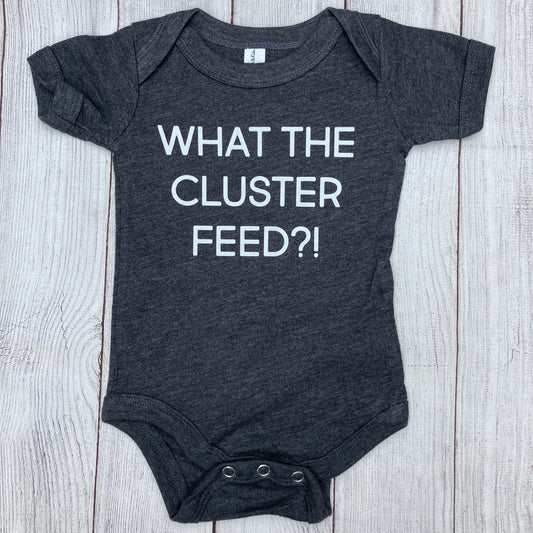 Grey baby bodysuit, "What the cluster feed?!" in white letters, baby, onesie, bodysuit, newborn, cluster feed, bf, breastfeeding, fed is best, breastfeeding mama, growth spurt, motherhood, new mom, nursing, pumping mom, colic