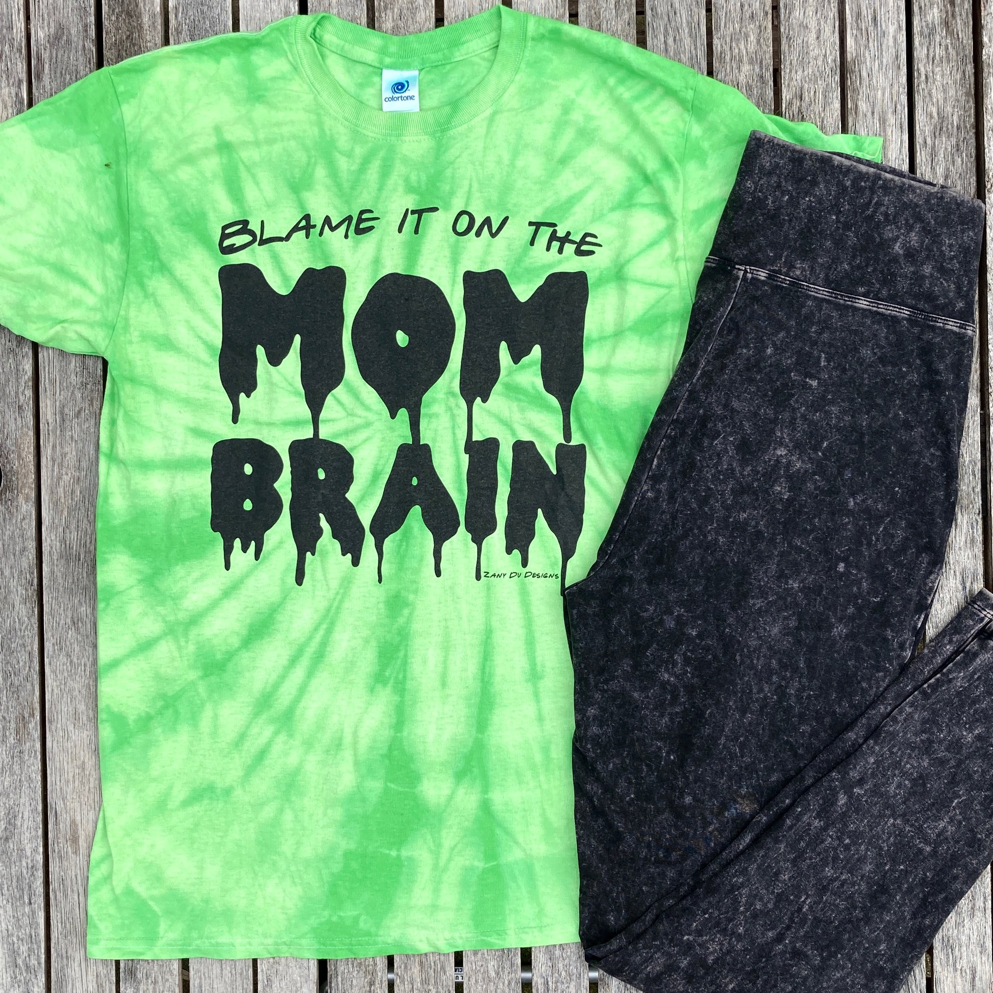 Slime green tie dye tee shirt with the writing saying, "BLAME IT ON THE MOM BRAIN", and the MOM BRAIN part has a slime font - Slime - Halloween - Spooky.