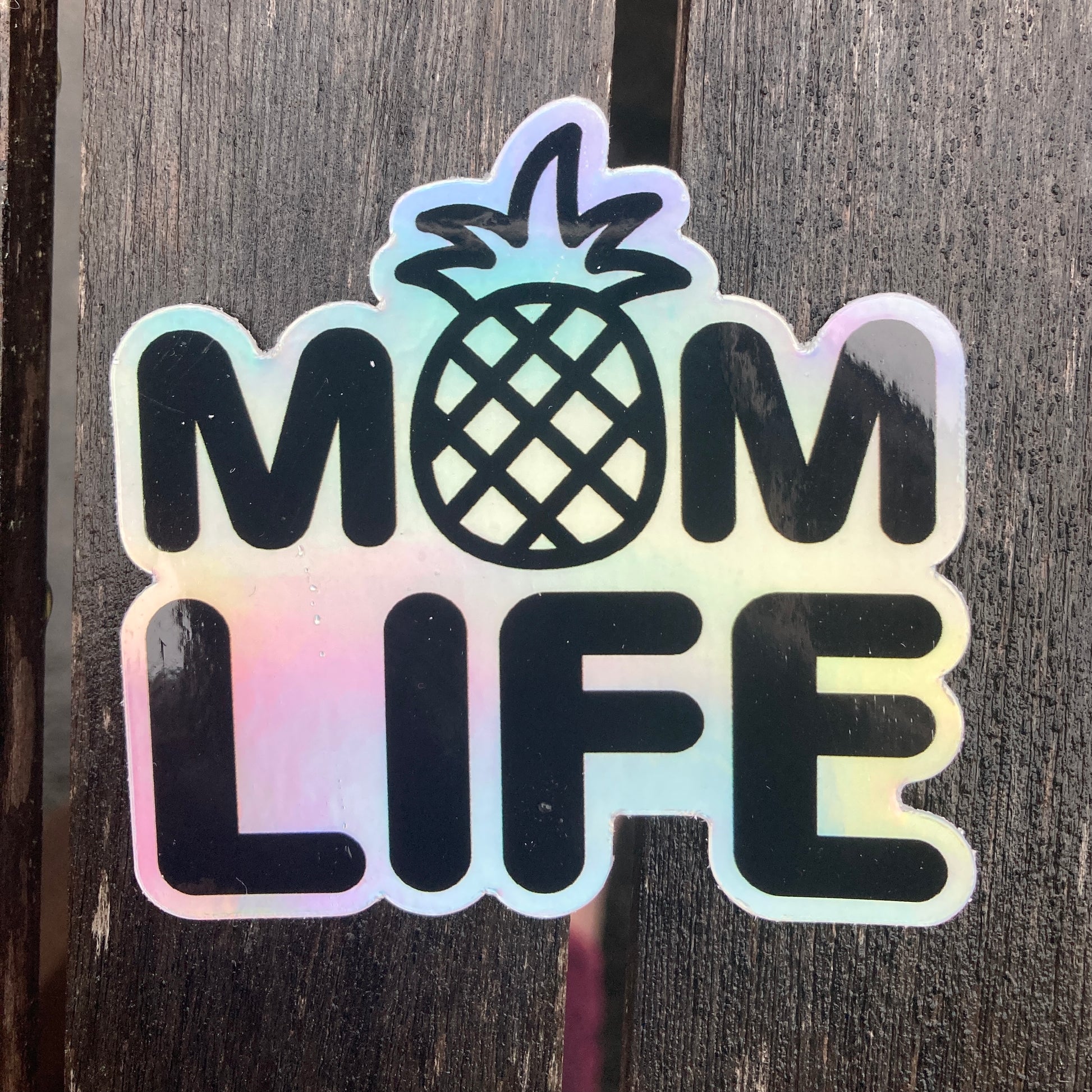 Holographic sticker with the writing saying, "MOM LIFE" and the O in the MOM is a pineapple