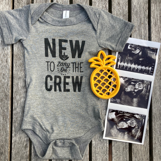 baby bodysuit in grey "new to the crew" contains zanydu logo- picture contains a pineapple teether and 3 ultrasound photos: new to the crew, baby announcement, pregnancy, baby, pregnant, birth announcement, gender reveal, first time mom, it's a...