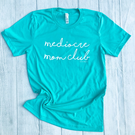 Sea foam t-shirt that says, "mediocre mom club" and it is in a cursive white font - short sleeve - tee - graphic tee - sea foam