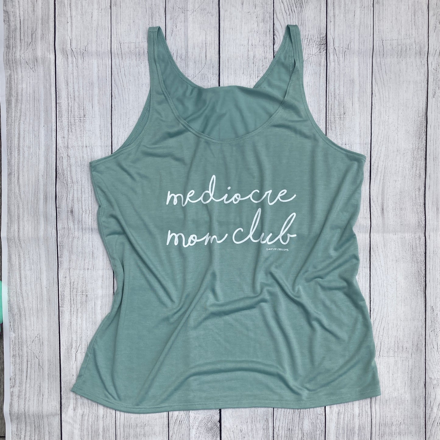 Light blue tank top with writing saying, "mediocre mom club",  - Flowy - Light Blue - Tank Top