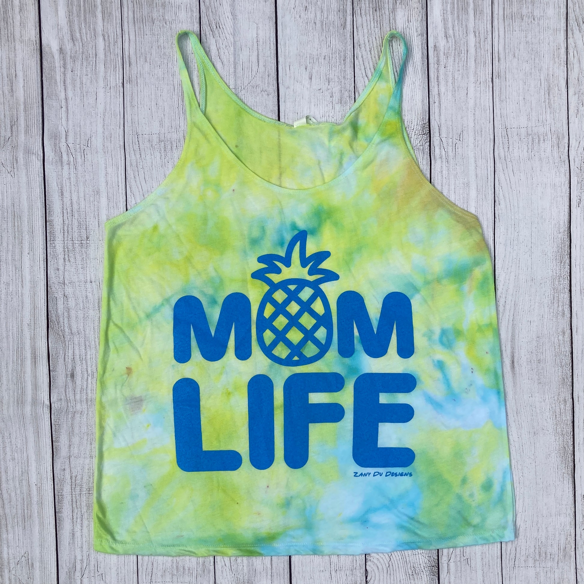Blue and green tie dye tank top with writing saying, "MOM LIFE" and the O in the MOM is a pineapple. - Tank top - Blue - Green - Pineapple - Tie Dye