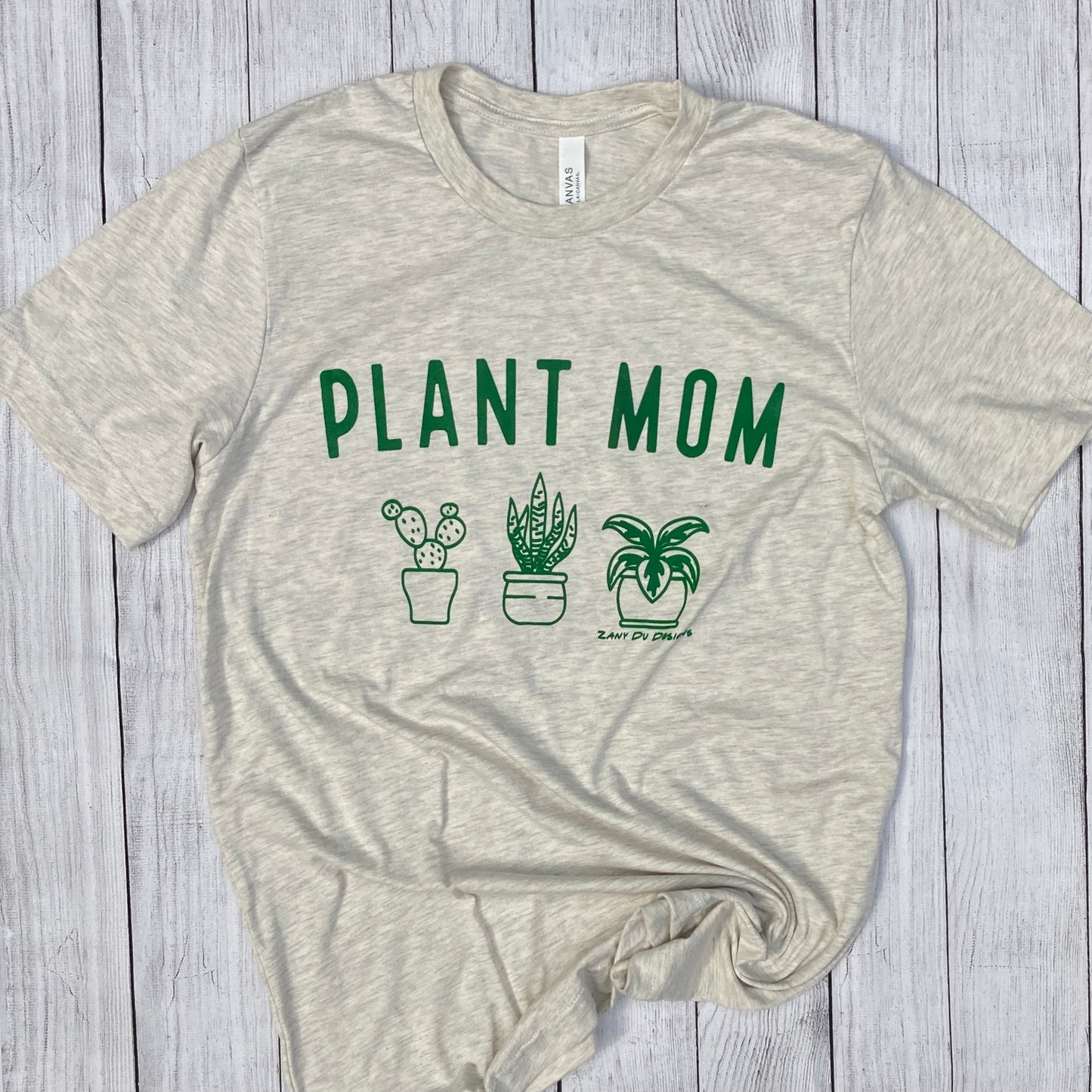 Heather Colored shirt with green font saying, "PLANT MOM" with 3 little plants under it. - Short sleeve - Summer Wear -