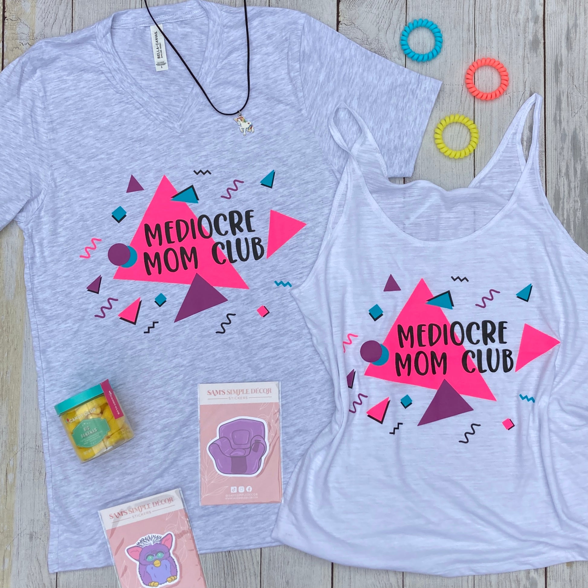 Tank top - 90's - Retro - Tank top with writing, "Mediocre Mom Club" Pink, Purple, and Blue font colors. Also a short sleeve deep v-neck with same writing and colors.