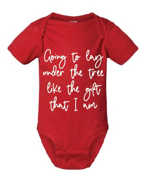 Red graphic tee, “going to lay under the tree like the gift that I am” script font in white, baby tee, kids tshirt, Christmas, holiday, Christmas tree, onesie, bodysuit, baby, newborn, baby's first christmas