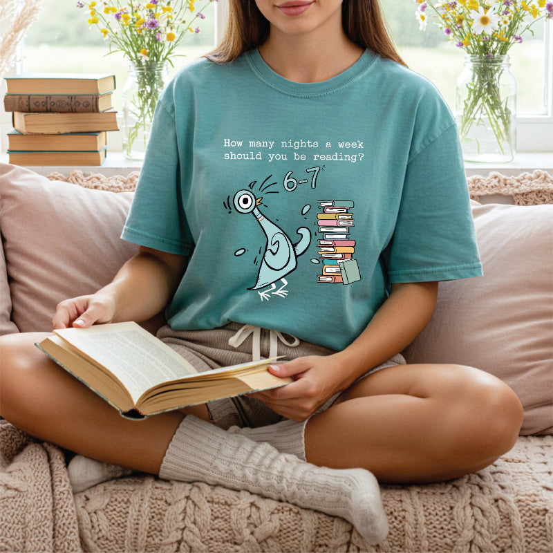 Woman wearing teal shirt that has a stack of books and pigeon on it asking how many nights a week should you resad? 6 7