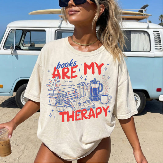 books are my therapy red and blue text on off white shirt on woman at beach