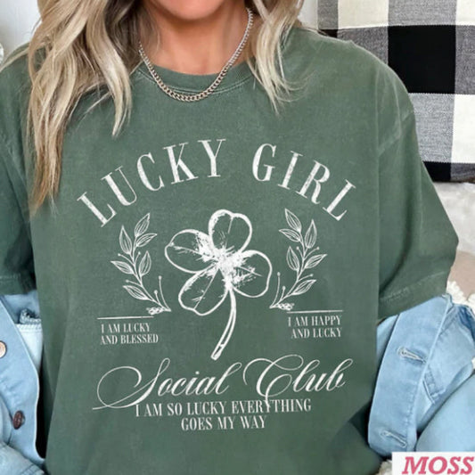 Green tshirt with 'Lucky Girl' graphic design worn by a woman.