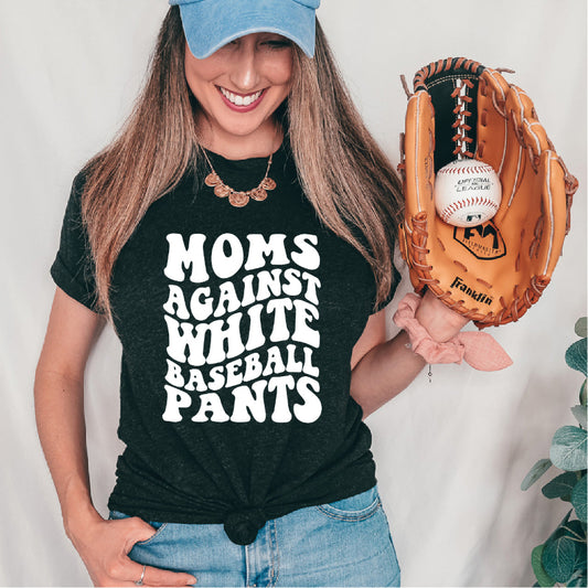Woman wearing a black t-shirt with 'Moms Against White Baseball Pants' text, holding a baseball glove with a ball.
