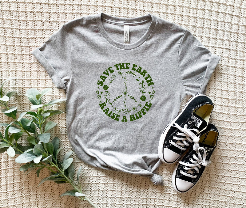 save the earth raise a hippie grey tee on a blanket background with black and white chucks