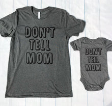 Grey t-shirt with the writing saying, "DON'T TELL MOM" in a bubble font - short sleeve - mom - siblings - dad - mom