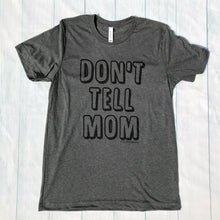 Grey t-shirt with the writing saying, "DON'T TELL MOM"  in a bubble font - short sleeve - mom - siblings - dad - mom