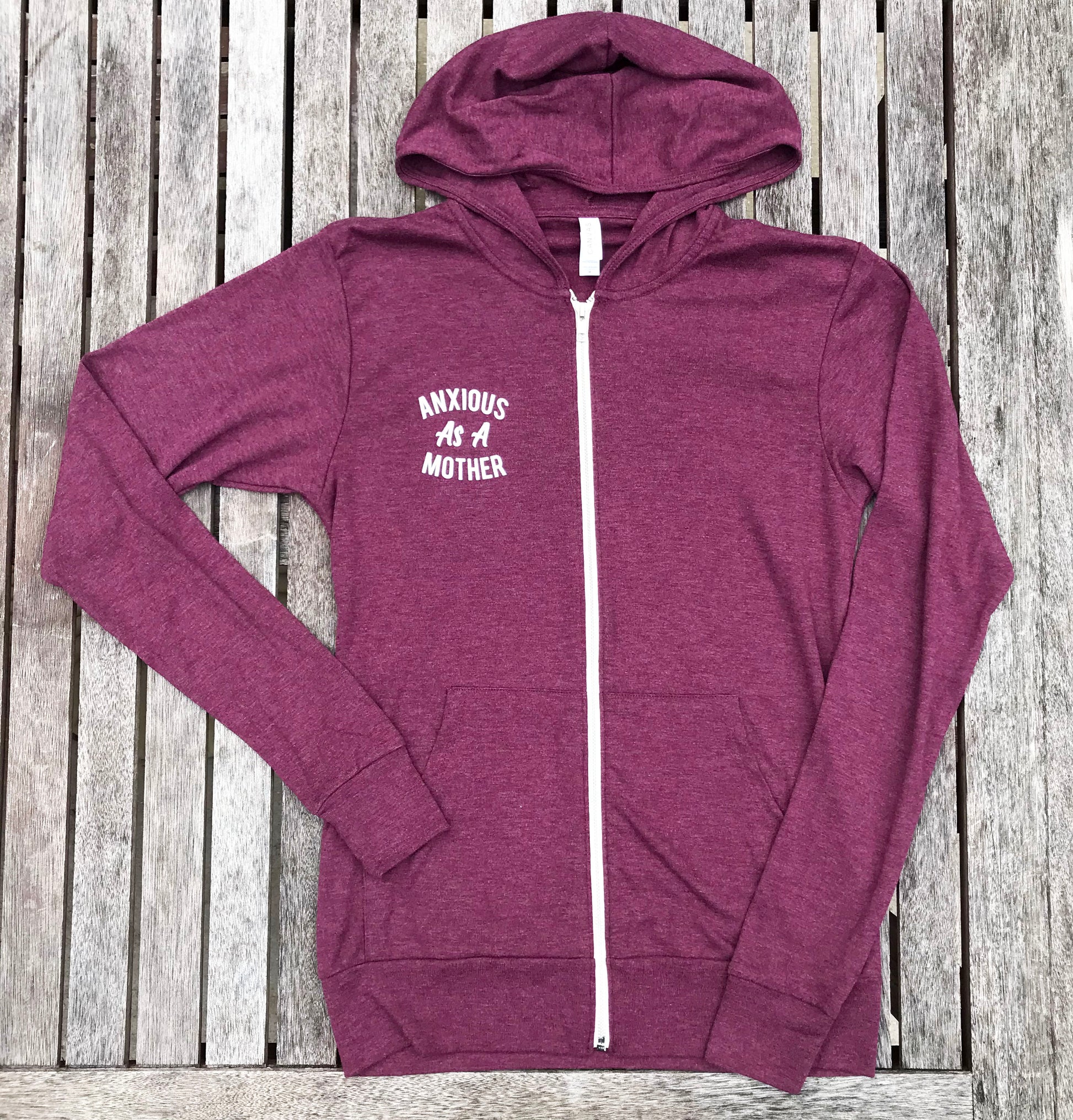 Heather maroon zip up sweatshirt that says, "ANXIOUS AS A MOTHER" on the back of the sweatshirt that's big and on the front of the sweatshirt that's small - winter - motherhood - mom life- crazy life - anxious - sweatshirt