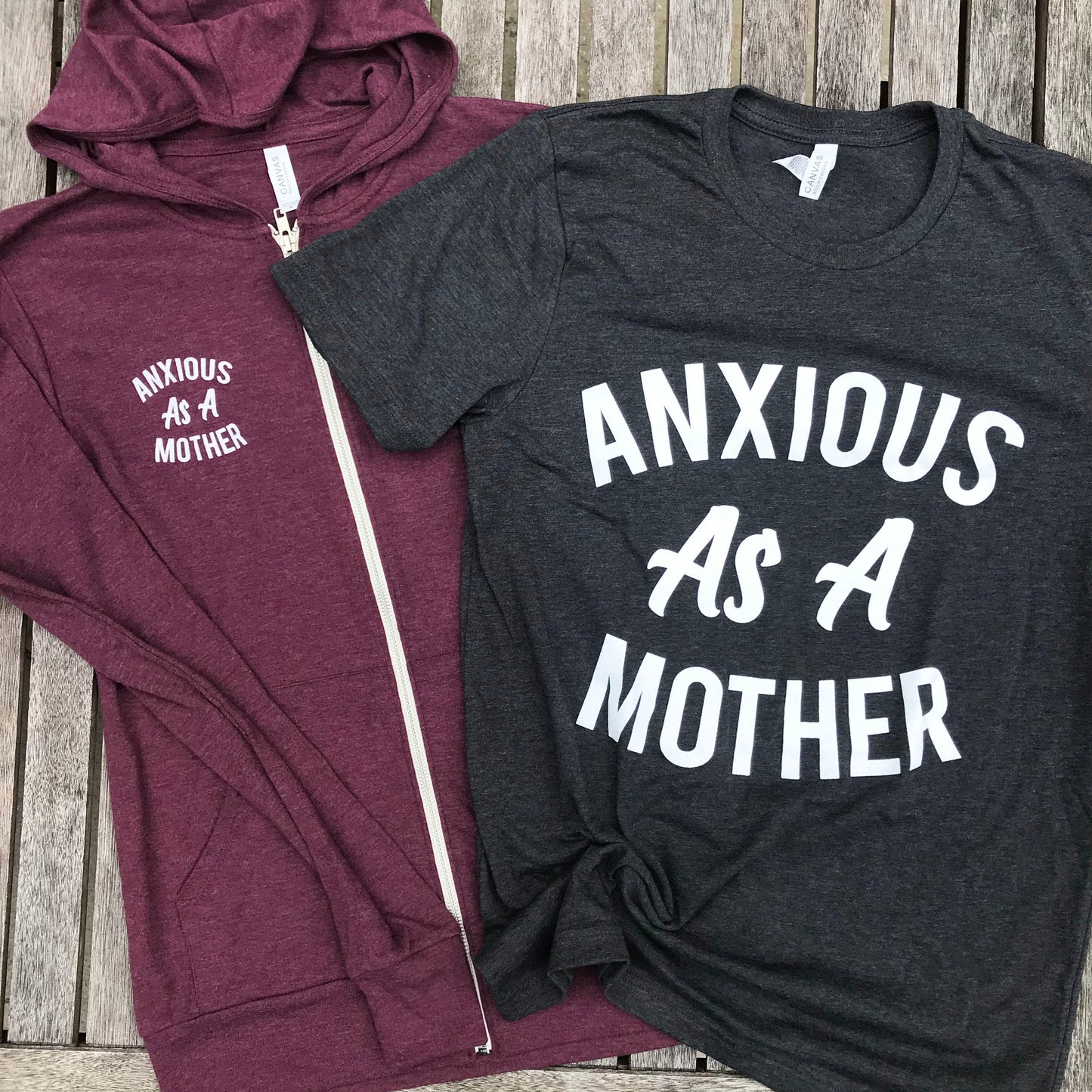 Heather maroon zip up sweatshirt that says, "ANXIOUS AS A MOTHER" on the back of the sweatshirt that's big and on the front of the sweatshirt that's small - winter - motherhood - mom life- crazy life - anxious - sweatshirt