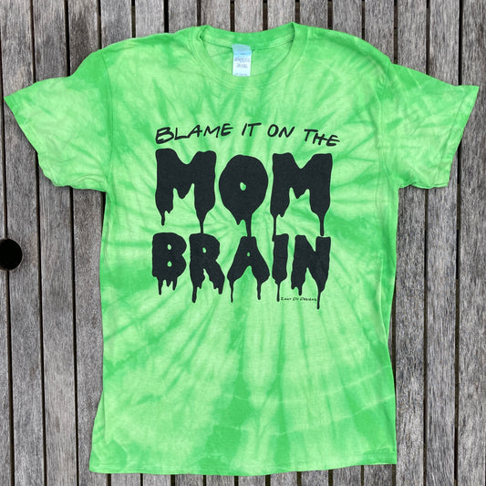 Slime green tie dye tee shirt with the writing saying, "BLAME IT ON THE MOM BRAIN", and the MOM BRAIN part has a slime font - Slime - Halloween - Spooky.