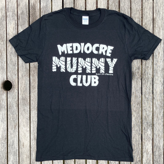 Black mummy club tee shirt with the writing saying, "MEDIOCRE MUMMY CLUB" 'Mummy' in a mummy wrapped font. 