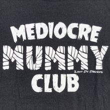 Black mummy club tee shirt with the writing saying, "MEDIOCRE MUMMY CLUB" 'Mummy' in a mummy wrapped font.