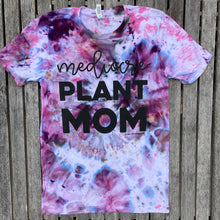 Blue, purple, and pink tie dye tee shirt that has the writing saying, "mediocre PLANT MOM"