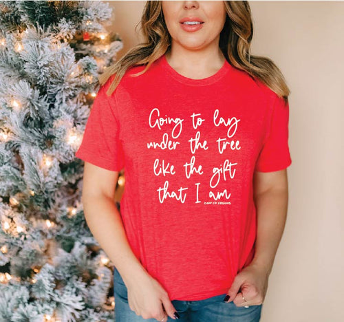 Red graphic tee, “going to lay under the tree like the gift that I am” script font in white, baby tee, graphic,  adult tshirt, Christmas, holiday, Christmas tree, 